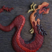 carved and painted wall piece